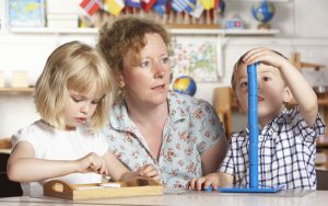 Teacher helping students